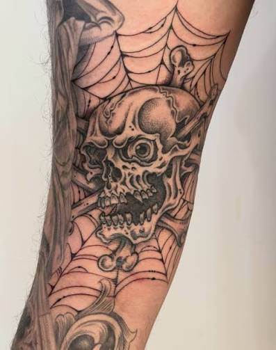 Skull and spiderweb sleeve tattoo